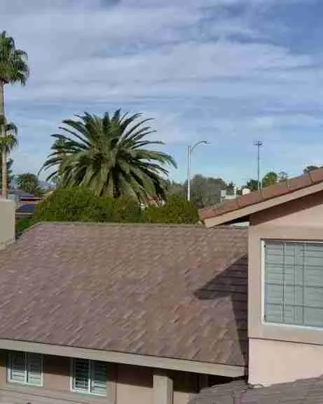 Professional roofer working on a residential roof - Roofing companies west palm beach